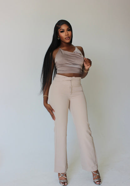 tall woman wearing beige straight-leg dress pants with asymmetrical waistline – front view