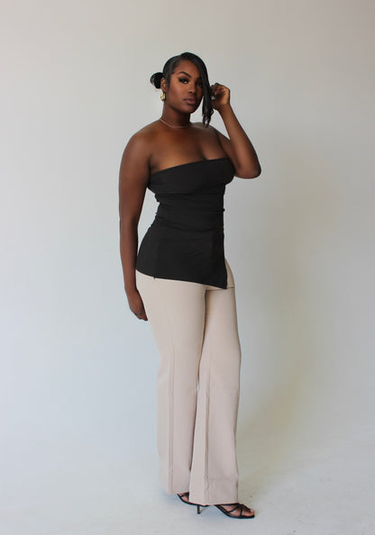 side angle of tall woman in irregular-cut brown tube top – luxury streetwear fit